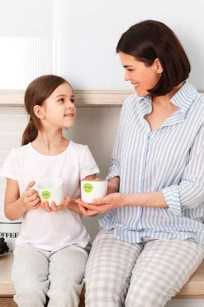 Busy working mom with kids drinking NutriBrownRice NutriBrownRice®️ Busy mom with girl having breakfast